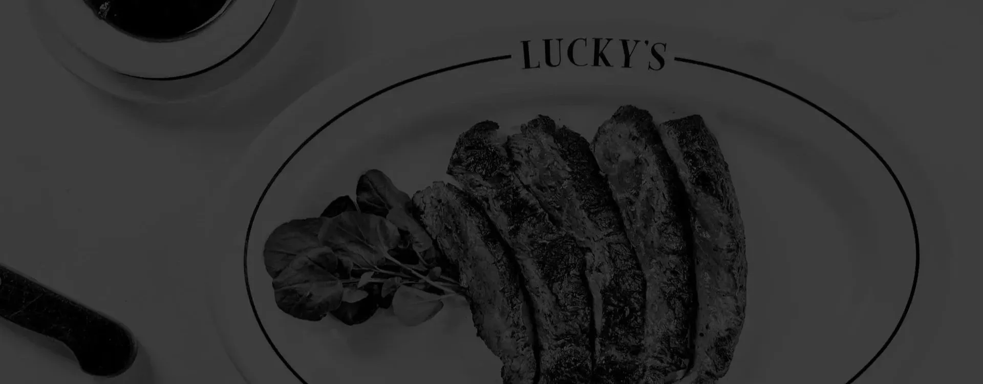 Plated steak dinner with classic sides at Lucky's Steakhouse